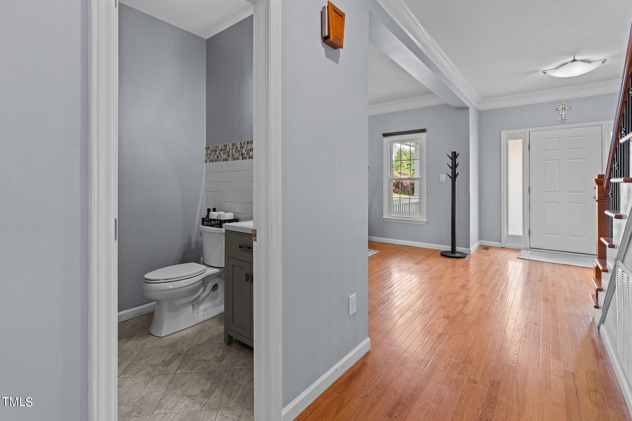 103 Summerglow Court Cary, NC 27513 - Photo 10 of 67 a bathroom with a toilet and a hardwood floor