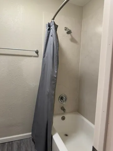 a bathroom with a tub and a shower