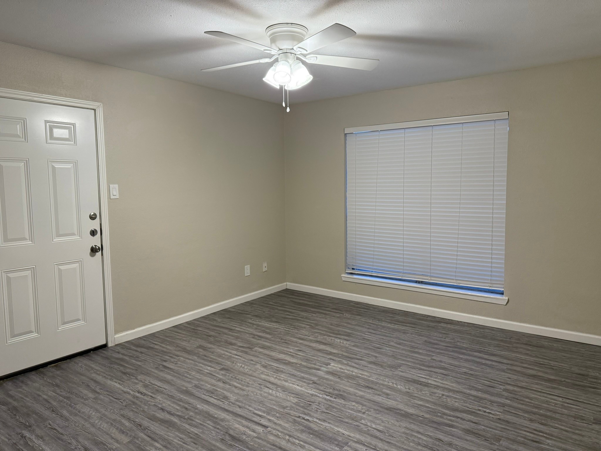 16303 Lyons School Road, Unit 907 Spring, TX 77379 - Photo 2 of 21 a view of an empty room with wooden floor