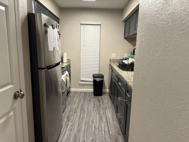 a kitchen with a refrigerator a washer and dryer