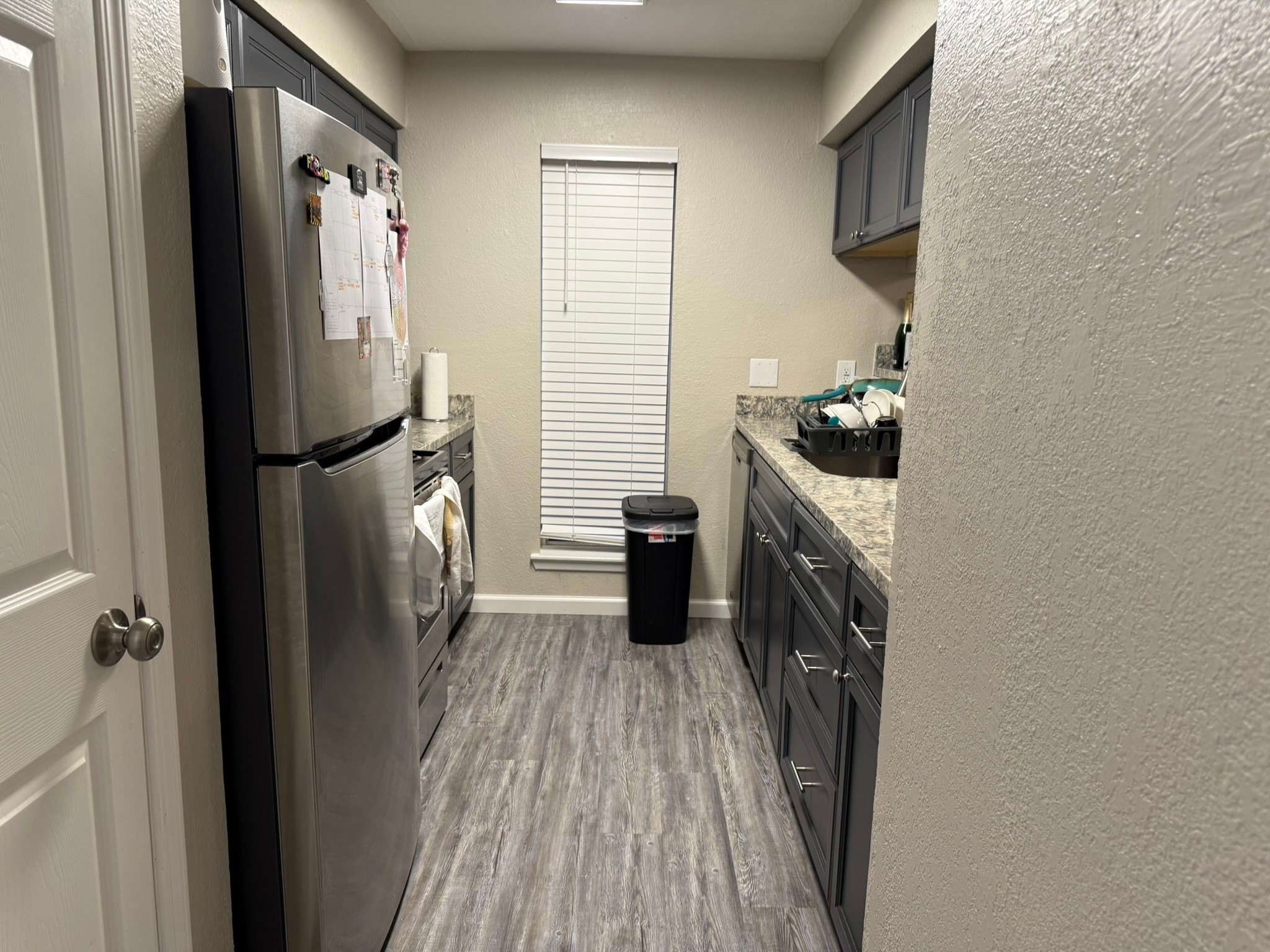 16303 Lyons School Road, Unit 907 Spring, TX 77379 - Photo 4 of 21 a kitchen with a refrigerator a washer and dryer