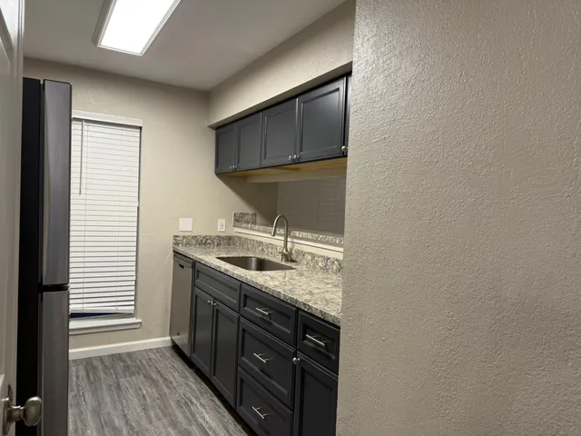 a kitchen with a sink and a stove