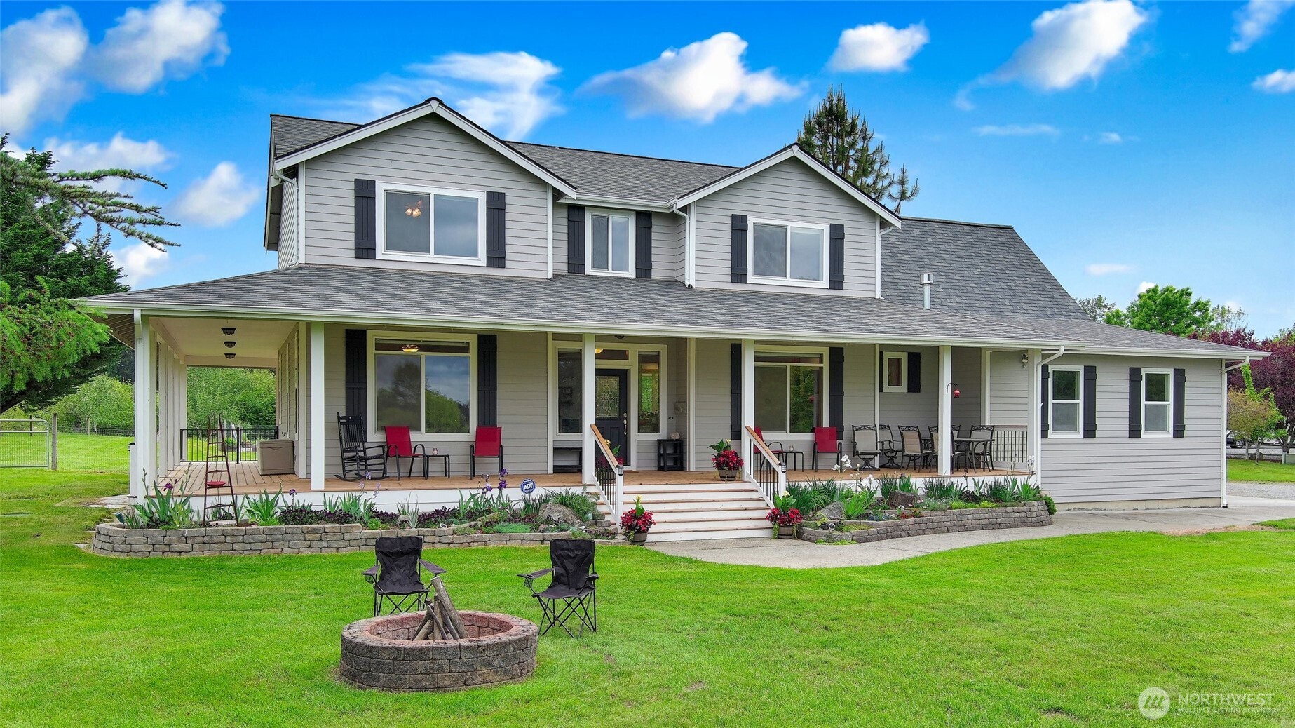 14419 Martinson Road Southeast Yelm, WA 98597 - Photo 1 of 39 a front view of a house with a yard table and chairs
