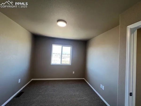 an empty room with closet area