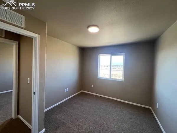 an empty room with closet area