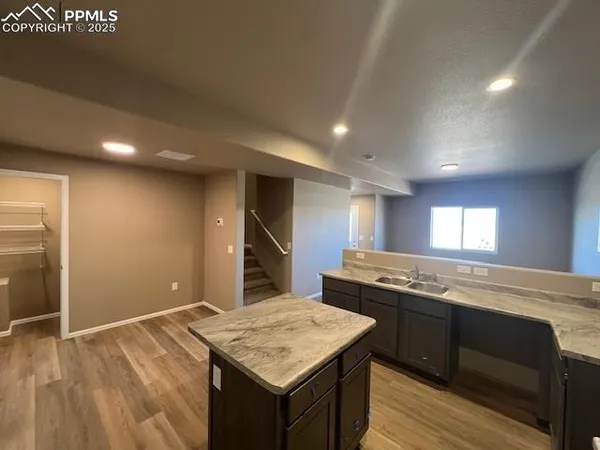 a kitchen with a stove a sink and a refrigerator