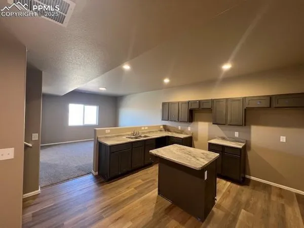 a kitchen with a sink and a stove top oven
