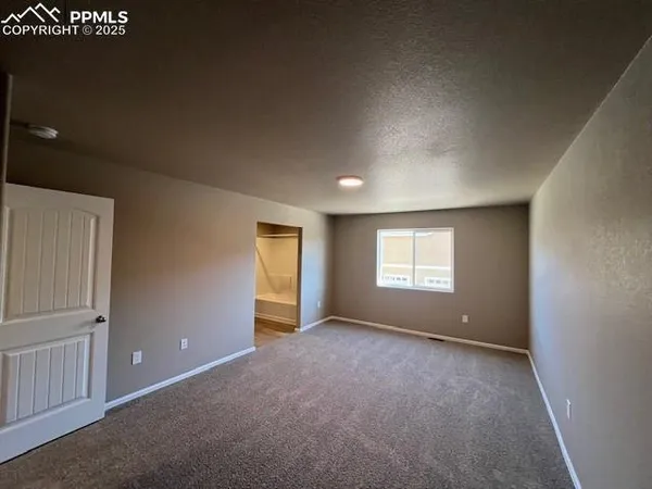 an empty room with wall & windows