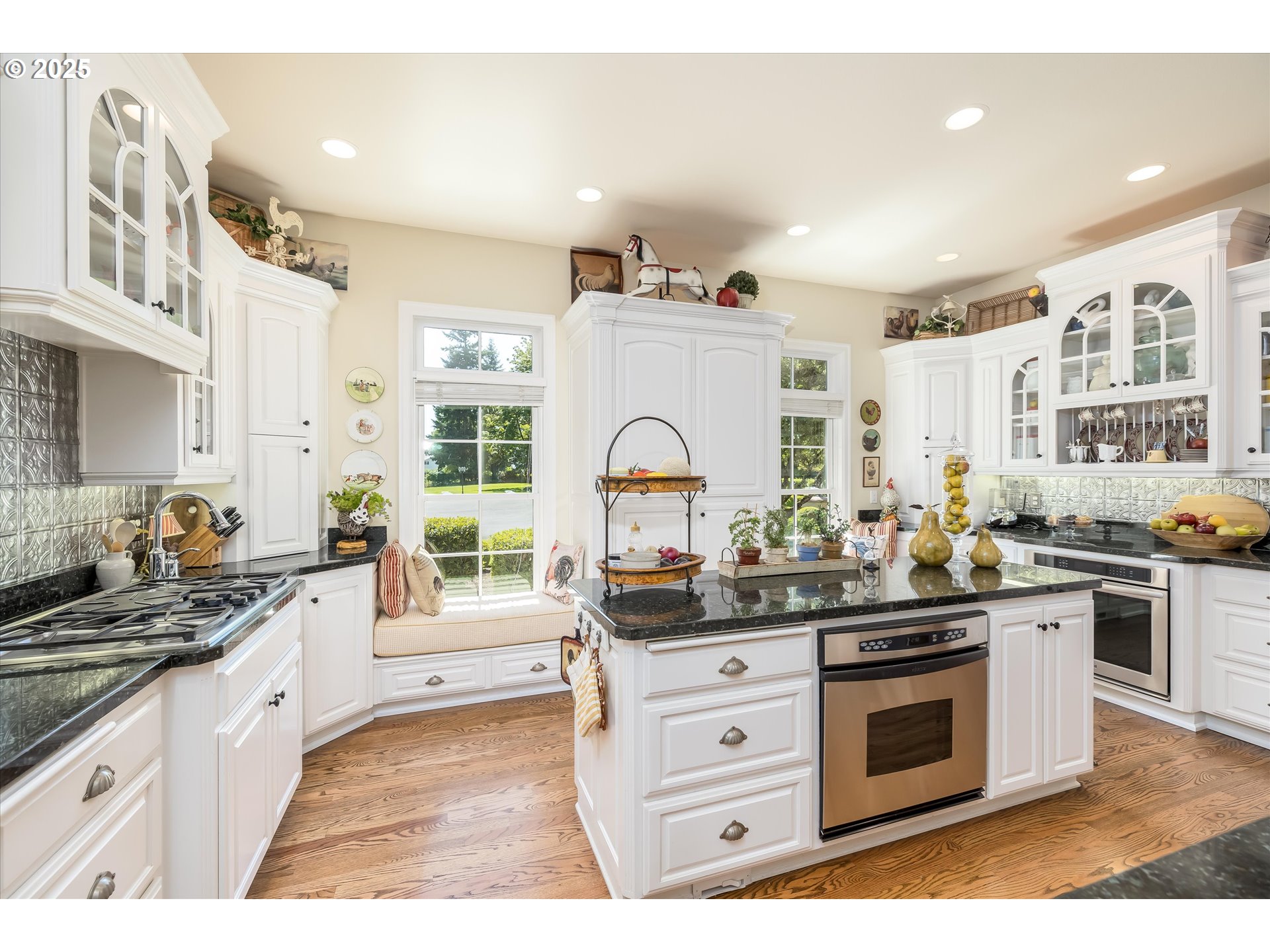 35853 Tennessee Road Southeast Albany, OR 97322 - Photo 15 of 48 a kitchen with stainless steel appliances kitchen island granite countertop a stove a sink dishwasher and white cabinets with wooden floor