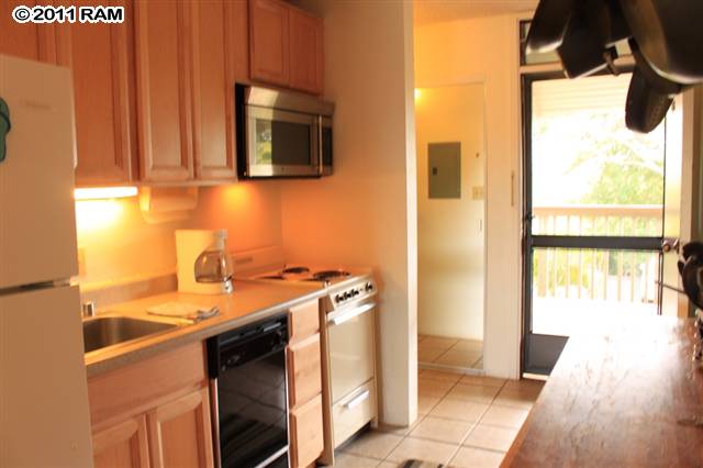715 South Kihei Road, Unit 226 Kihei, HI 96753 - Photo 12 of 26 a kitchen with a sink a stove and a microwave