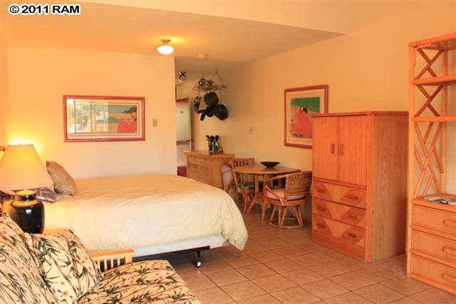 715 South Kihei Road, Unit 226 Kihei, HI 96753 - Photo 3 of 26 a bedroom with a bed and a table in it