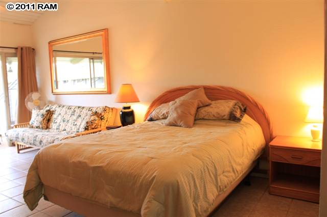 715 South Kihei Road, Unit 226 Kihei, HI 96753 - Photo 4 of 26 a large bed sitting in a bedroom next to a window