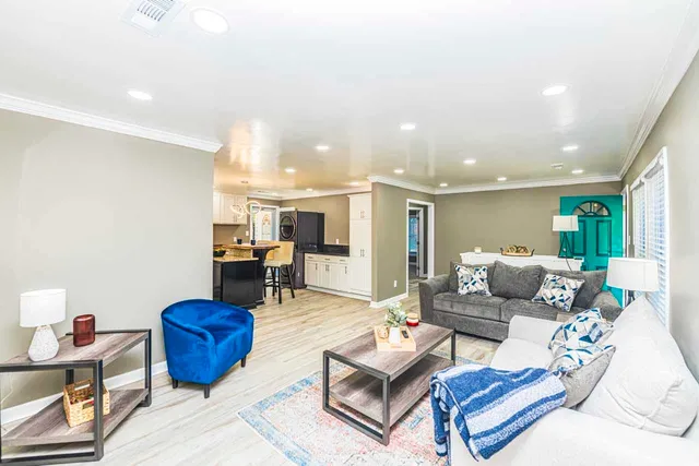 a living room with furniture and wooden floor