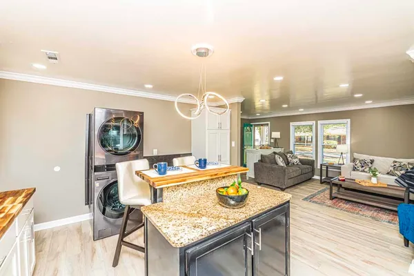 a living room with furniture and wooden floor