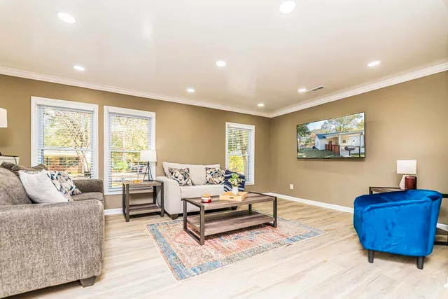 a living room with furniture and a flat screen tv