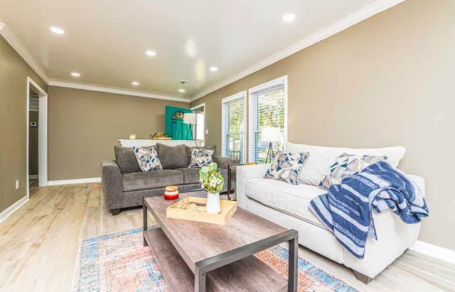 a living room with furniture and a large window