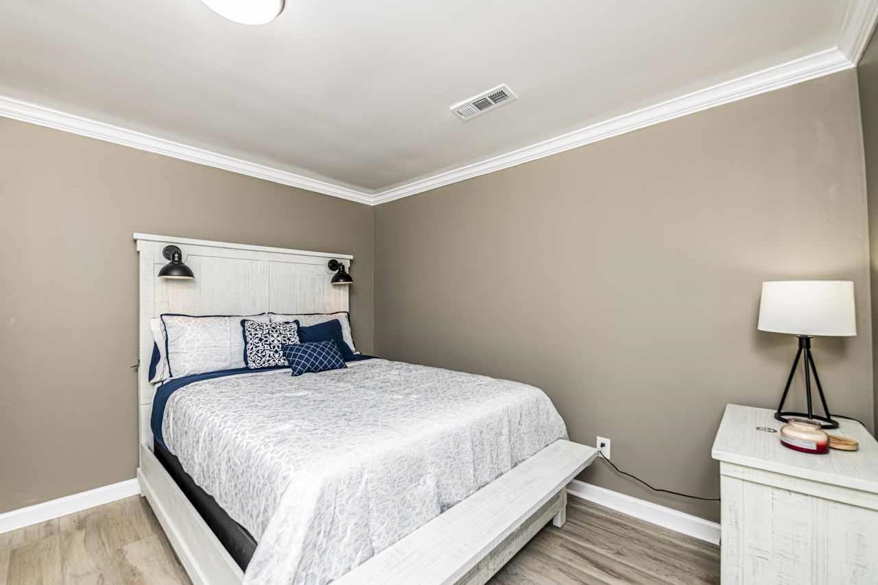715 South Maple Street Covington, TN 38019 - Photo 28 of 33 a bedroom with a bed and a table