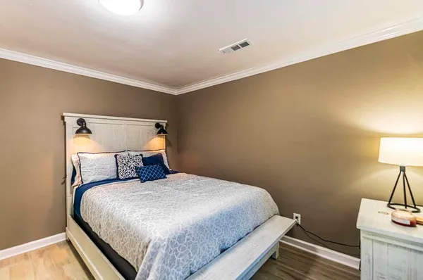 a bed sitting in a bedroom next to a window