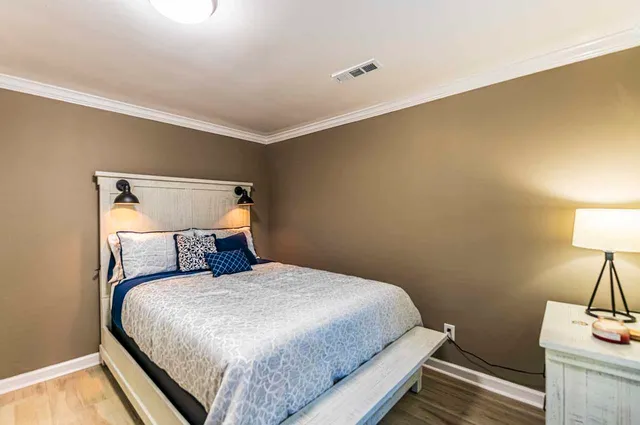 a bedroom with a bed and lamps