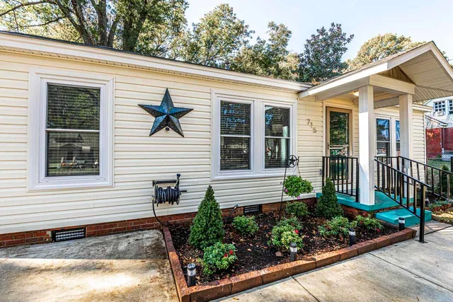 a front view of a house with garden