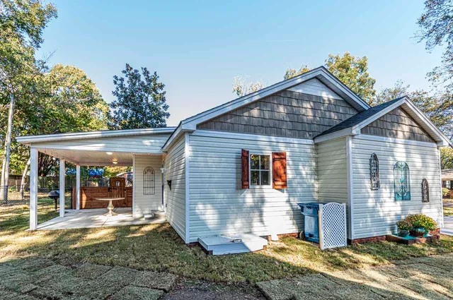 a view of a house with a yard and floor to ceiling window