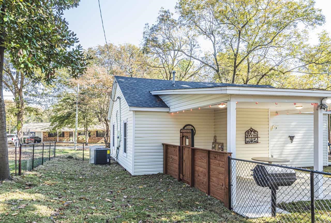 715 South Maple Street Covington, TN 38019 - Photo 9 of 33 a view of a house with backyard and a tree