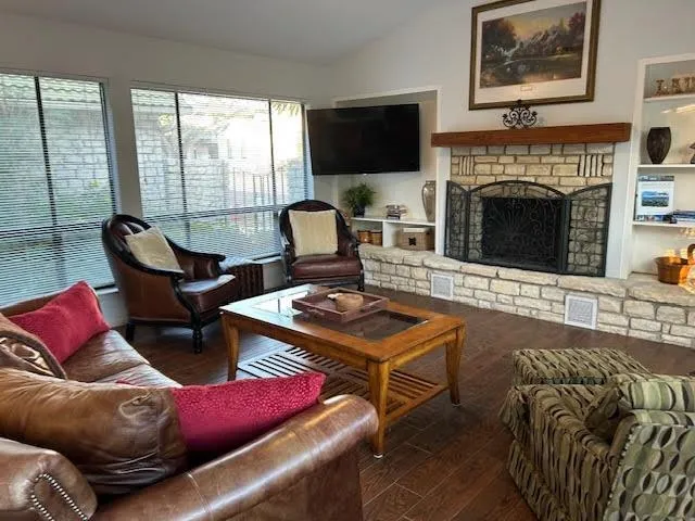 a living room with furniture fireplace and flat screen tv
