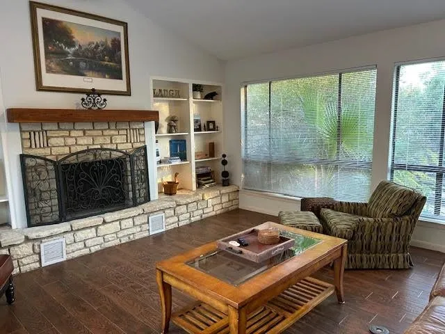a living room with furniture a flat screen tv and a fireplace