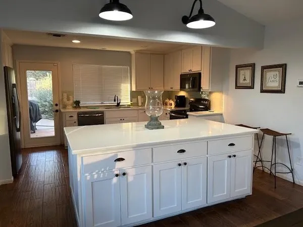 a kitchen with a sink stainless steel appliances and cabinets