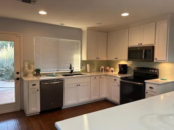 a kitchen with a sink stove and microwave