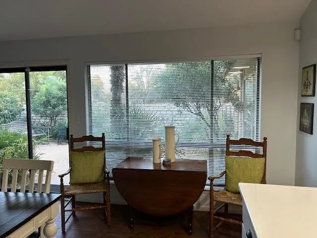 a dining room with furniture and wooden floor