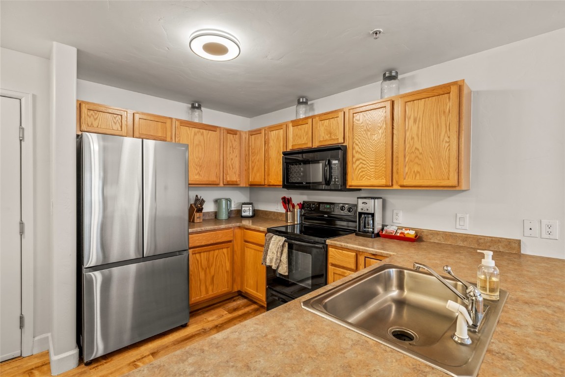 2545 Cattle Kate Circle, Unit 3207 Steamboat Springs, CO 80487 - Photo 12 of 42 a kitchen with stainless steel appliances a refrigerator sink and microwave