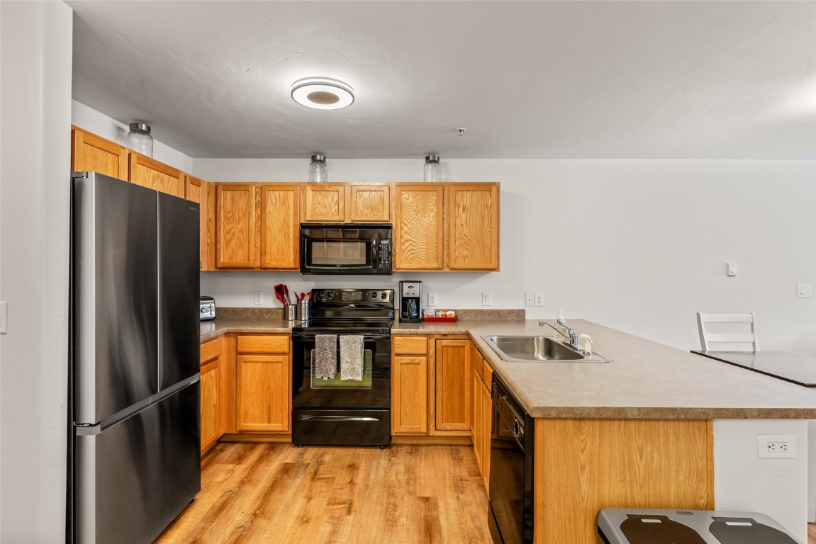 2545 Cattle Kate Circle, Unit 3207 Steamboat Springs, CO 80487 - Photo 13 of 42 a kitchen with stainless steel appliances a refrigerator sink and microwave