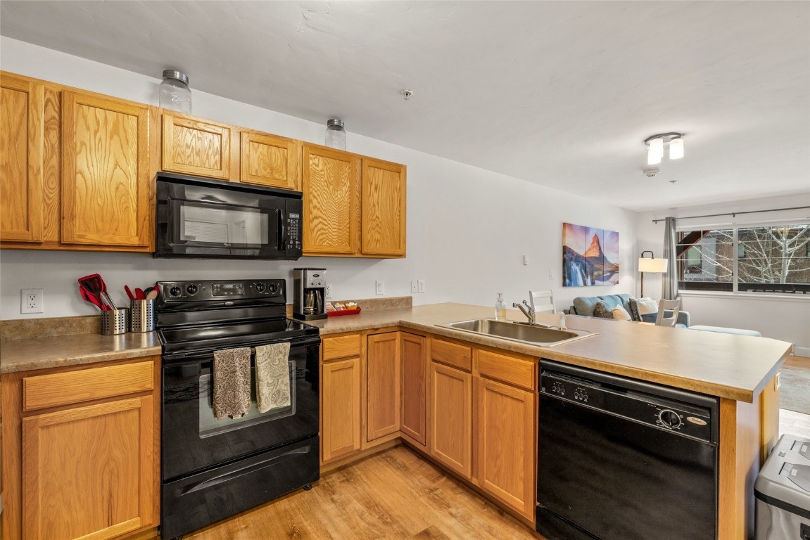 2545 Cattle Kate Circle, Unit 3207 Steamboat Springs, CO 80487 - Photo 14 of 42 a kitchen with stainless steel appliances granite countertop a stove microwave and sink