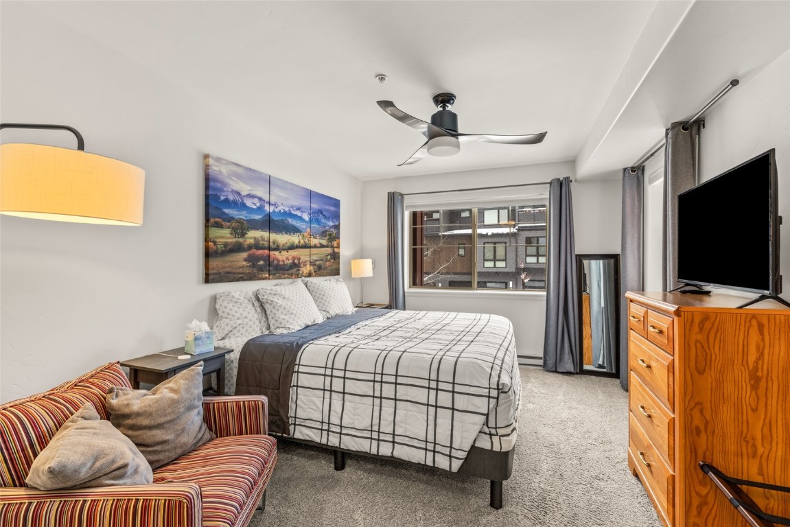 2545 Cattle Kate Circle, Unit 3207 Steamboat Springs, CO 80487 - Photo 17 of 42 a bedroom with furniture and a flat screen tv