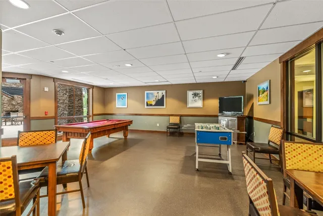 a living room with pool table and pool table