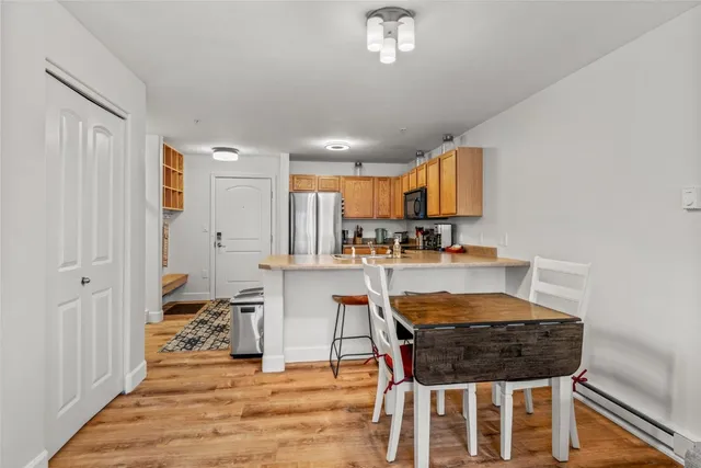 a dining room with furniture and wooden floor