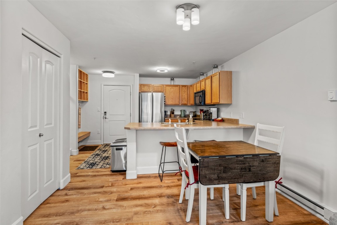 2545 Cattle Kate Circle, Unit 3207 Steamboat Springs, CO 80487 - Photo 10 of 42 a dining room with furniture and wooden floor