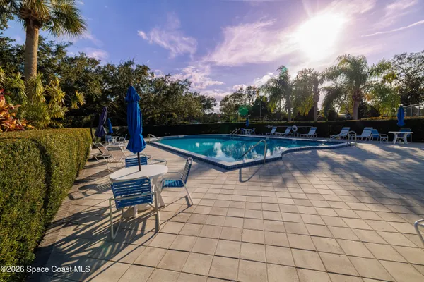 a view of a swimming pool with outdoor seating