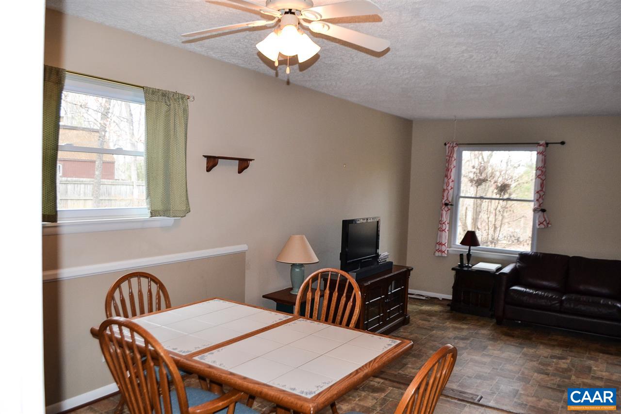 2738 Rio Mills Road Earlysville, VA 22936 - Photo 35 of 48 a view of a dining room with furniture a chandelier and a window