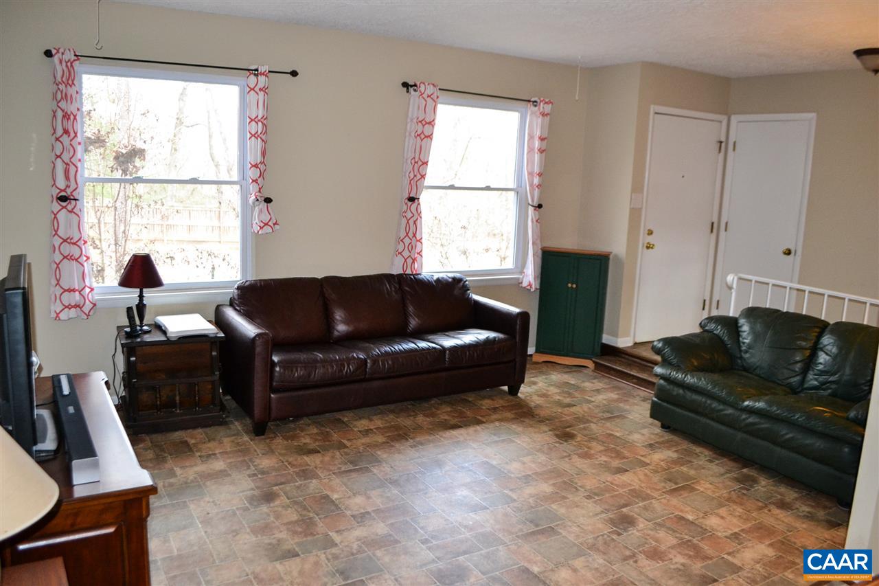 2738 Rio Mills Road Earlysville, VA 22936 - Photo 36 of 48 a living room with furniture window and a flat screen tv