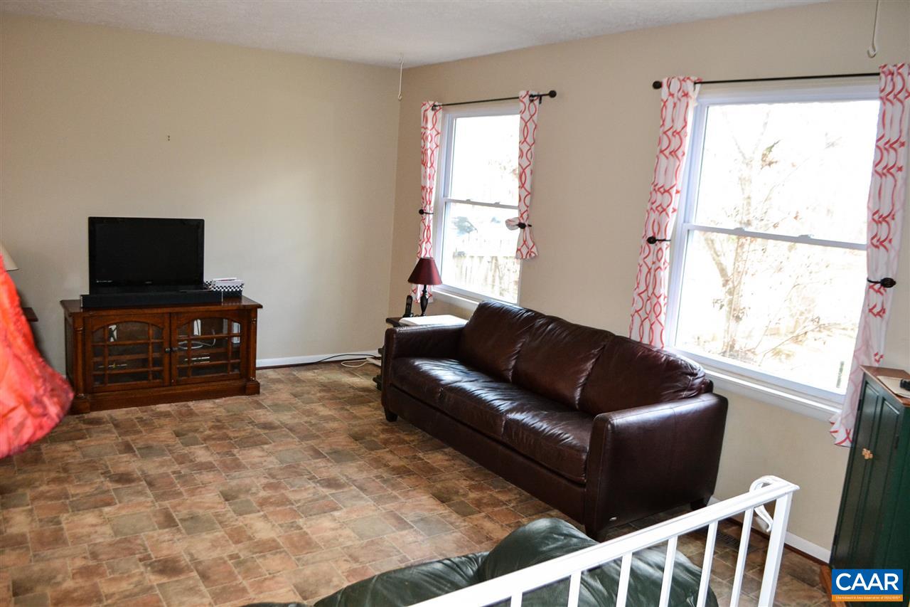 2738 Rio Mills Road Earlysville, VA 22936 - Photo 38 of 48 a living room with furniture and a flat screen tv