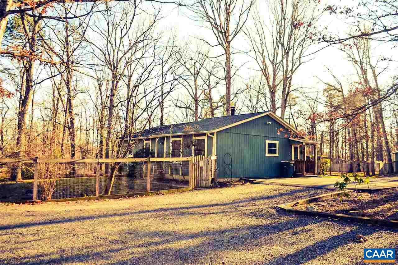 2738 Rio Mills Road Earlysville, VA 22936 - Photo 4 of 48 a front view of a house with a yard covered with trees