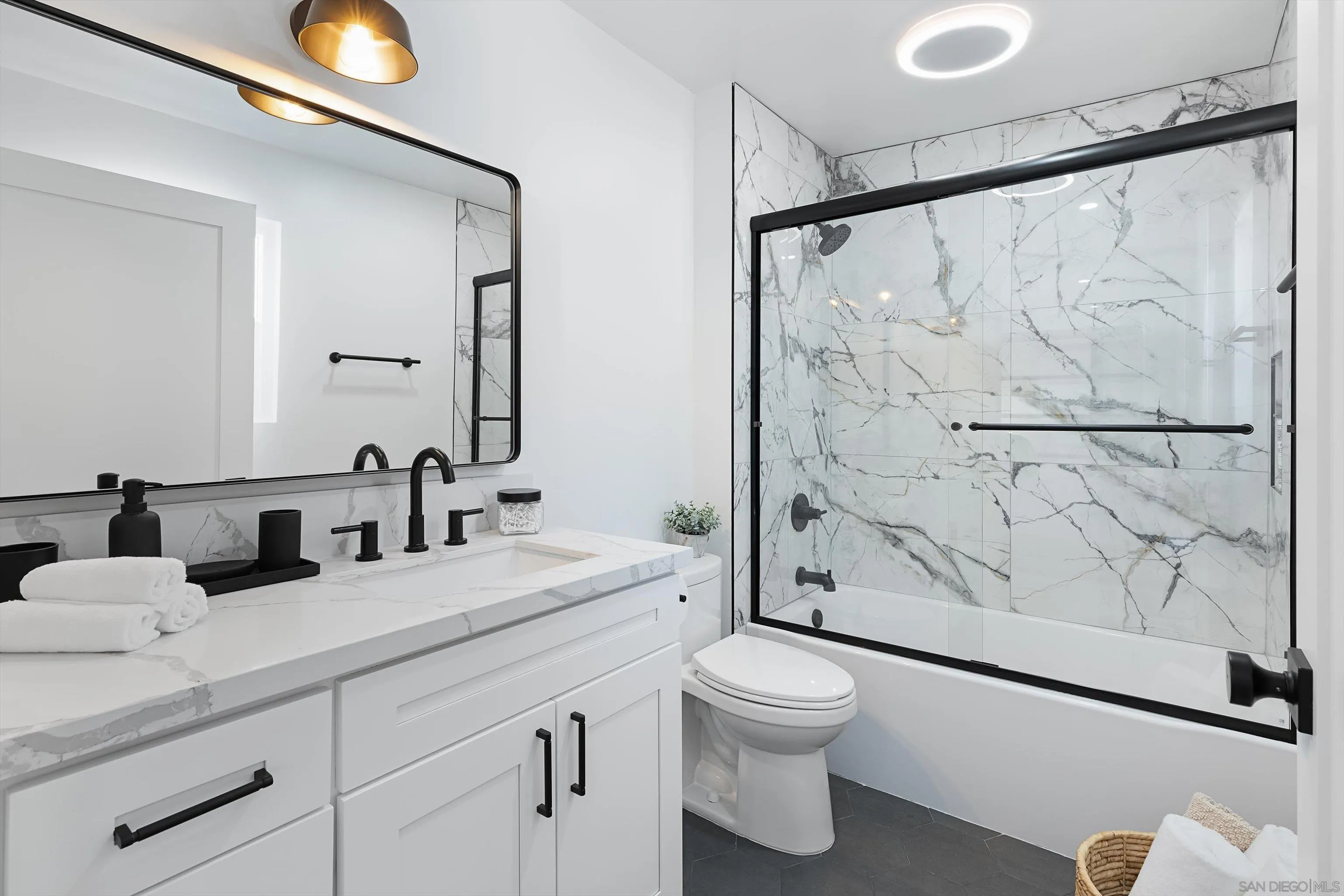 6111 Rancho Mission Road, Unit 313 San Diego, CA 92108 - Photo 18 of 25 a bathroom with a double vanity sink toilet and shower