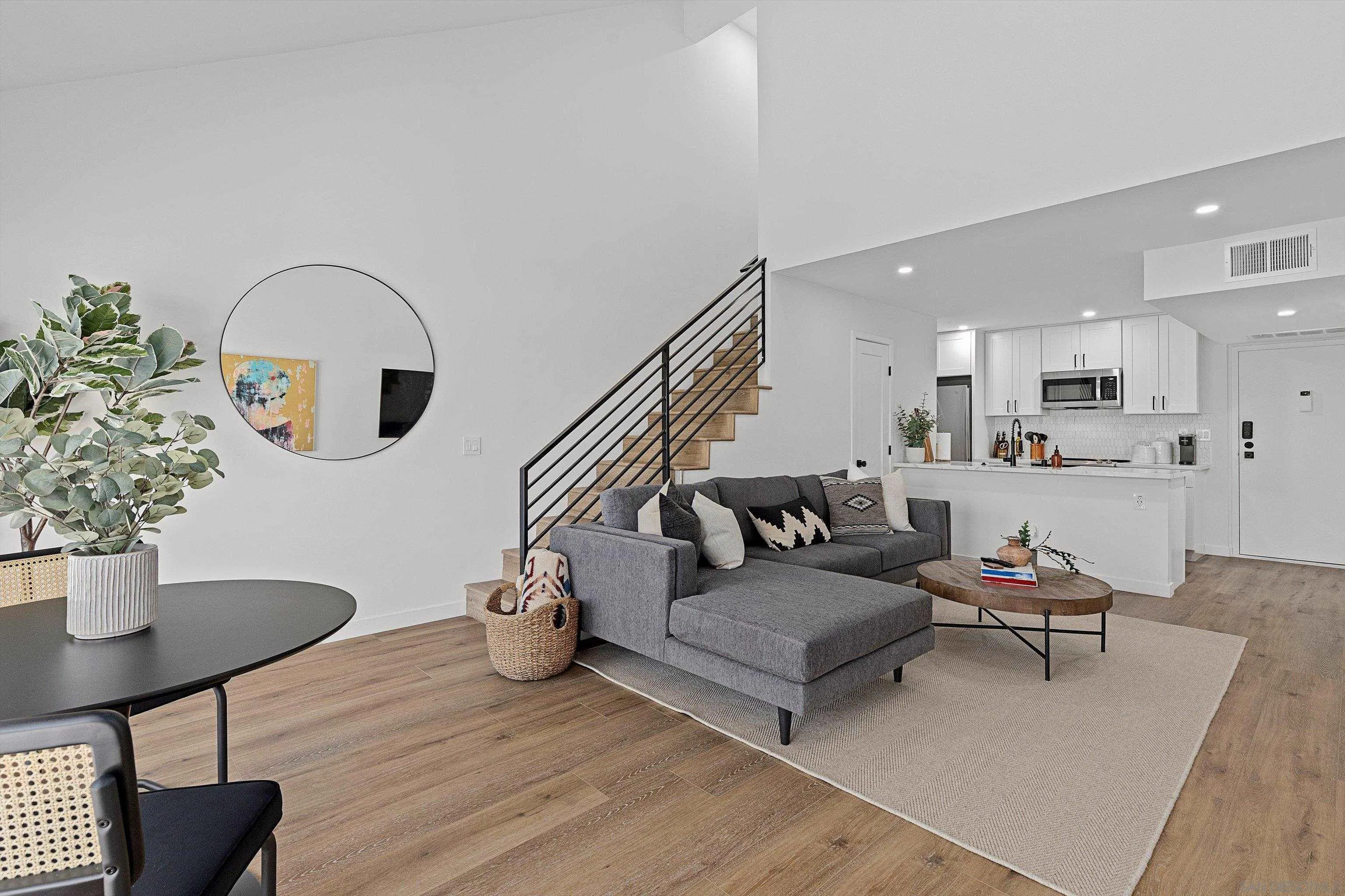 6111 Rancho Mission Road, Unit 313 San Diego, CA 92108 - Photo 2 of 25 a living room with furniture and a potted plant