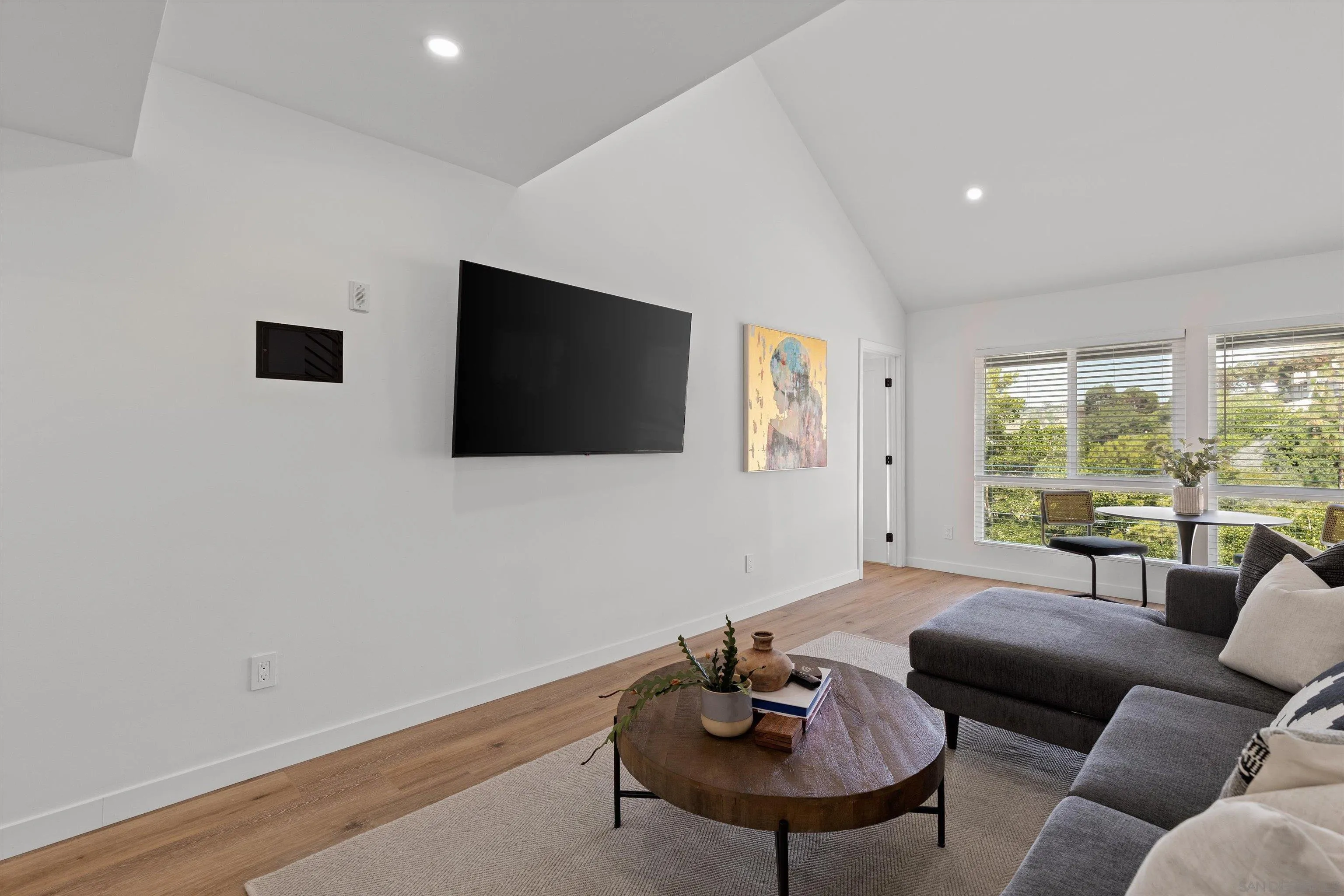 6111 Rancho Mission Road, Unit 313 San Diego, CA 92108 - Photo 4 of 25 a living room with furniture and a flat screen tv