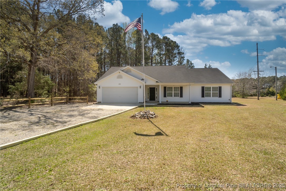 2830 John McMillan Road Hope Mills, NC 28348 - Photo 1 of 46 a house with trees in front of it