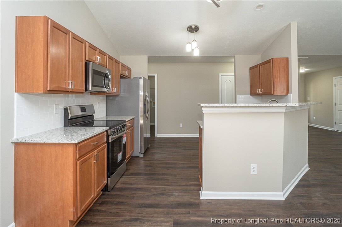 2830 John McMillan Road Hope Mills, NC 28348 - Photo 14 of 46 a kitchen with stainless steel appliances granite countertop a stove a sink and a refrigerator