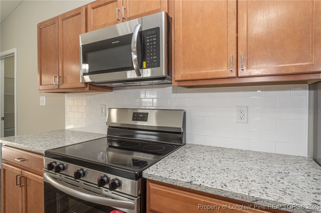 2830 John McMillan Road Hope Mills, NC 28348 - Photo 17 of 46 a kitchen with a stove and a microwave