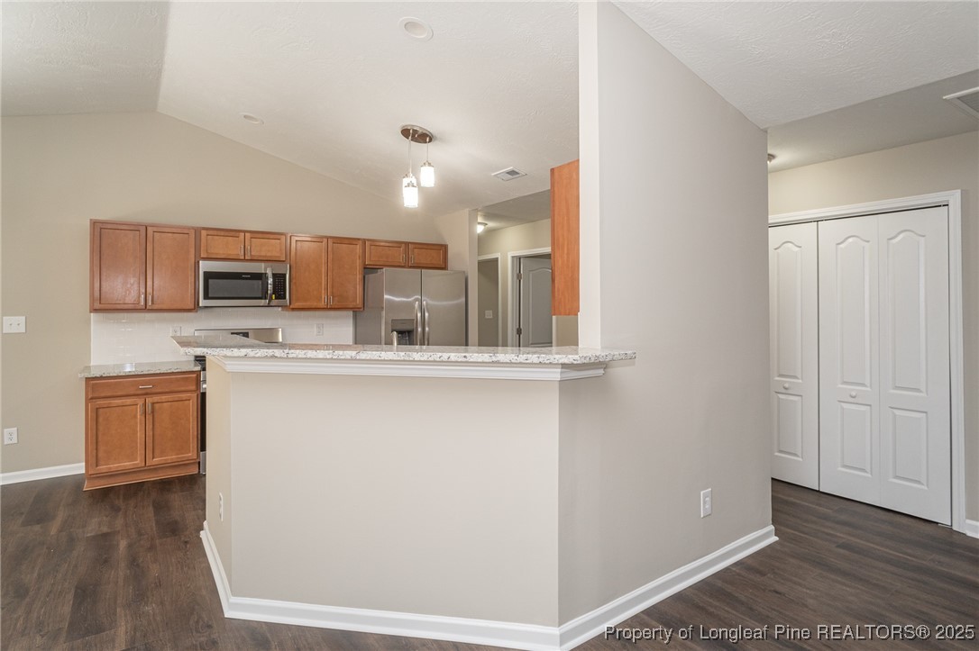 2830 John McMillan Road Hope Mills, NC 28348 - Photo 18 of 46 a kitchen with stainless steel appliances granite countertop a refrigerator sink and microwave